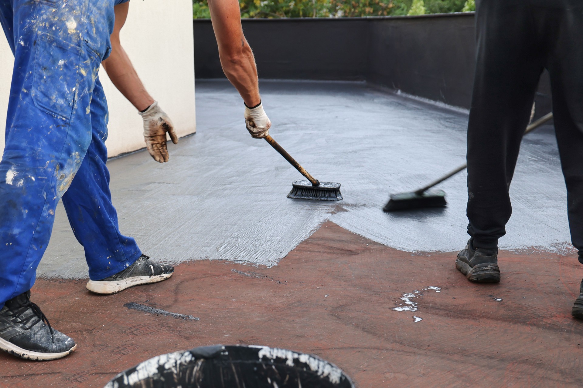 Two Workers Applying a Roof Waterproofing